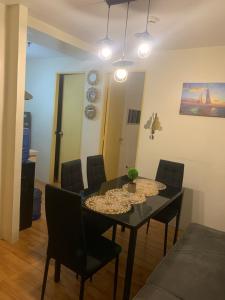 a dining room with a black table and chairs at Seawind Condominiums Tower 1,3,4,5 in Davao City