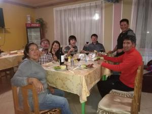 a group of people sitting around a table eating at "Eucalyptus Uyuni" in Uyuni