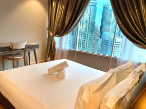 Ένα ή περισσότερα κρεβάτια σε δωμάτιο στο Stella Maison KLCC