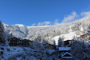 a resort in the mountains covered in snow at Apartments Schmittental - Schmitten62 Self Check-In in Zell am See