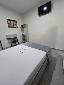 a room with a bed and a tv on the wall at Singular hotel in Sao Paulo