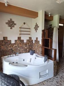 a large white bath tub in a room at Casa de la chakana Chakana House Sacred Valley in Calca