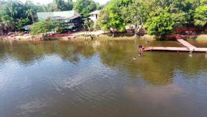 a person is standing in the middle of a lake at Itaúba Hotel Restaurante Eco-resort in Puerto Sucre +2 photos