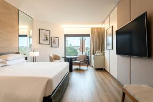a hotel room with a bed and a flat screen tv at Sheraton Buenos Aires Hotel & Convention Center in Buenos Aires