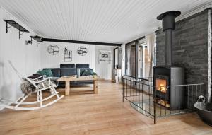 a living room with a couch and a fireplace at 3 Bedroom Lovely Home In Kirke Hyllinge in Kirke-Hyllinge