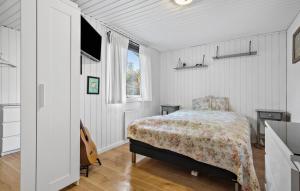 a bedroom with a bed and a guitar in it at 3 Bedroom Lovely Home In Kirke Hyllinge in Kirke-Hyllinge +9 photos
