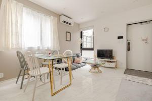 a dining room with a glass table and chairs at residence MINAMI-AOYAMA102 in Tokyo