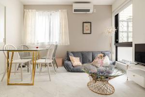 a living room with a table and a couch at residence MINAMI-AOYAMA102 in Tokyo