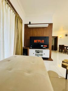 a hotel room with a bed and a television at 6Floor in society Ecity ph2 Near TCS Tech Mahindra in Bengaluru