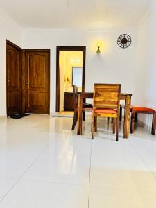 a dining room with a wooden table and chairs at 6Floor in society Ecity ph2 Near TCS Tech Mahindra in Bengaluru