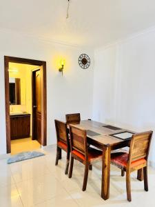 a dining room with a wooden table and chairs at 6Floor in society Ecity ph2 Near TCS Tech Mahindra in Bengaluru