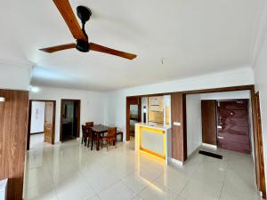 a living room with a ceiling fan and a table at 6Floor in society Ecity ph2 Near TCS Tech Mahindra in Bengaluru