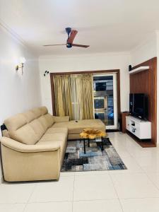 a living room with a couch and a coffee table at 6Floor in society Ecity ph2 Near TCS Tech Mahindra in Bengaluru