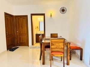 a dining room with a wooden table and chairs at 6Floor in society Ecity ph2 Near TCS Tech Mahindra in Bengaluru