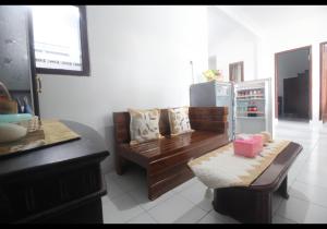 a living room with a couch and a refrigerator at Griya Indah Homestay in Pacet