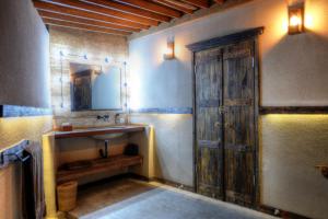 a bathroom with a sink and a mirror at Hammerhead Villa, SHOTI Gili in Gili Trawangan