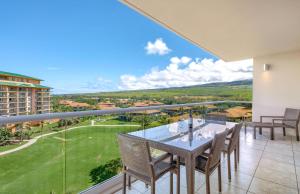 a balcony with a table and chairs and a view at Honua Kai Resort And Spa By Maui Resort Rentals in Lahaina