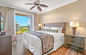 a bedroom with a large bed and a large window at Honua Kai Resort And Spa By Maui Resort Rentals in Lahaina