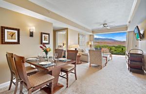 a dining room with a table and chairs and a living room at Honua Kai Resort And Spa By Maui Resort Rentals in Lahaina