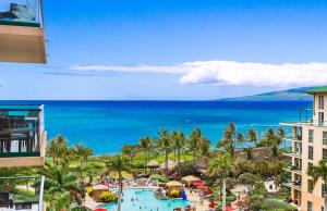 a view of a resort with a pool and the ocean at Honua Kai Resort And Spa By Maui Resort Rentals in Lahaina