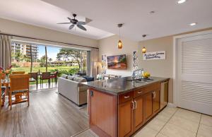 a kitchen and living room with a couch and a ceiling fan at Honua Kai Resort And Spa By Maui Resort Rentals in Lahaina