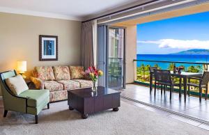 a living room with a couch and a table at Honua Kai Resort And Spa By Maui Resort Rentals in Lahaina