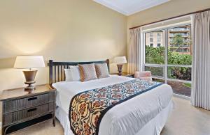 a bedroom with a large bed and a window at Honua Kai Resort And Spa By Maui Resort Rentals in Lahaina