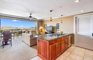 a kitchen with a view of a living room at Honua Kai Resort And Spa By Maui Resort Rentals in Lahaina