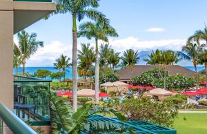 a view of a resort with palm trees and umbrellas at Honua Kai Resort And Spa By Maui Resort Rentals in Lahaina