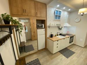 a kitchen with a white refrigerator and a sink at MOM Boutique Rooms in Budapest +13 photos
