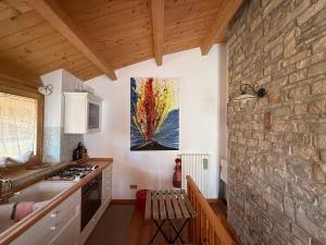 a kitchen with a painting hanging on the wall at Nel cuore di Castel di Sangro La Casa di Cristina in Castel di Sangro