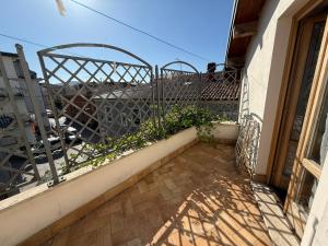 a balcony with a fence and plants on a building at Nel cuore di Castel di Sangro La Casa di Cristina in Castel di Sangro