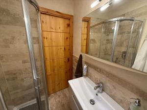 a bathroom with a sink and a shower and a mirror at Nel cuore di Castel di Sangro La Casa di Cristina in Castel di Sangro +34 photos