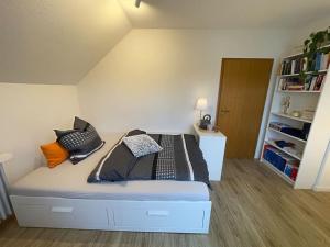 a bedroom with a bed with pillows on it at Stilvolles Studio in Vallendar