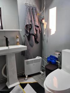 a bathroom with a sink and a toilet at Sky loft house in Almaty +22 photos