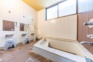 a bathroom with two toilets and a large tub at Guesthouse Sunaen - Vacation STAY 49055v in Tottori