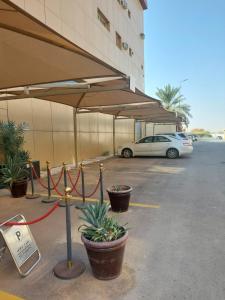 a parking lot with a car parked in it at Zievle Executive Apartments in Buraydah