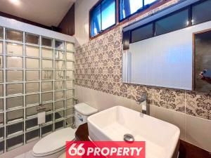 a bathroom with a white toilet and a sink at Nature Getaway in Classic Thai Home - Quiet Local Life in Chiang Mai +40 photos