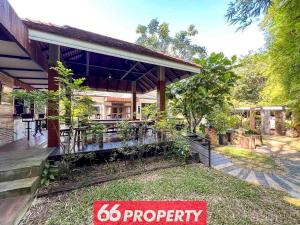 a house with a property sign in front of it at Nature Getaway in Classic Thai Home - Quiet Local Life in Chiang Mai