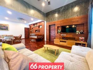 a living room with a couch and a television at Nature Getaway in Classic Thai Home - Quiet Local Life in Chiang Mai
