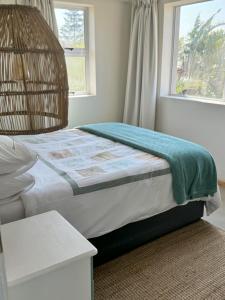 a bedroom with a bed and a window at Secrets 2 at Waterkant 7 in Jeffreys Bay