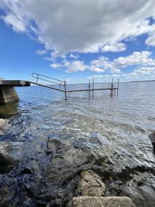 a dock in the water next to a body of water at A SENSE OF PLACE LIMIT 17 villa in North Sebago