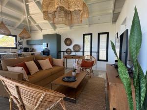 a living room with a couch and a table at Villa Lauviah in Ravine Sèche