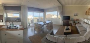 a living room with a couch and a table at Secrets 2 at Waterkant 7 in Jeffreys Bay