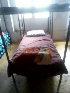 a bedroom with a bunk bed with a book on it at Himalayan Mountain View, Triund Trekking Hostel in Dharamshala +6 photos