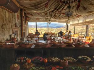 a room filled with lots of plates of food at Mithra Cave Hotel in Goreme