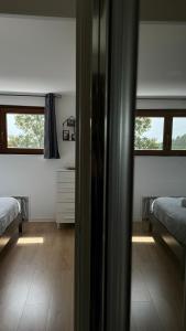 a view of a bedroom with two beds and a window at Attico Stella Alpina in Terminillo