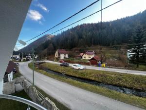 a view of a road with a white car on the road at 3izbový rodinný dom s krbom in Ružomberok