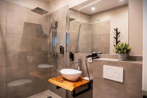 a bathroom with a sink and a glass shower at Liro Hotel Viersen in Viersen +45 photos