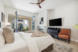 a bedroom with a bed and a flat screen tv at T21 Lux Villa With Fountain View Condo in La Quinta